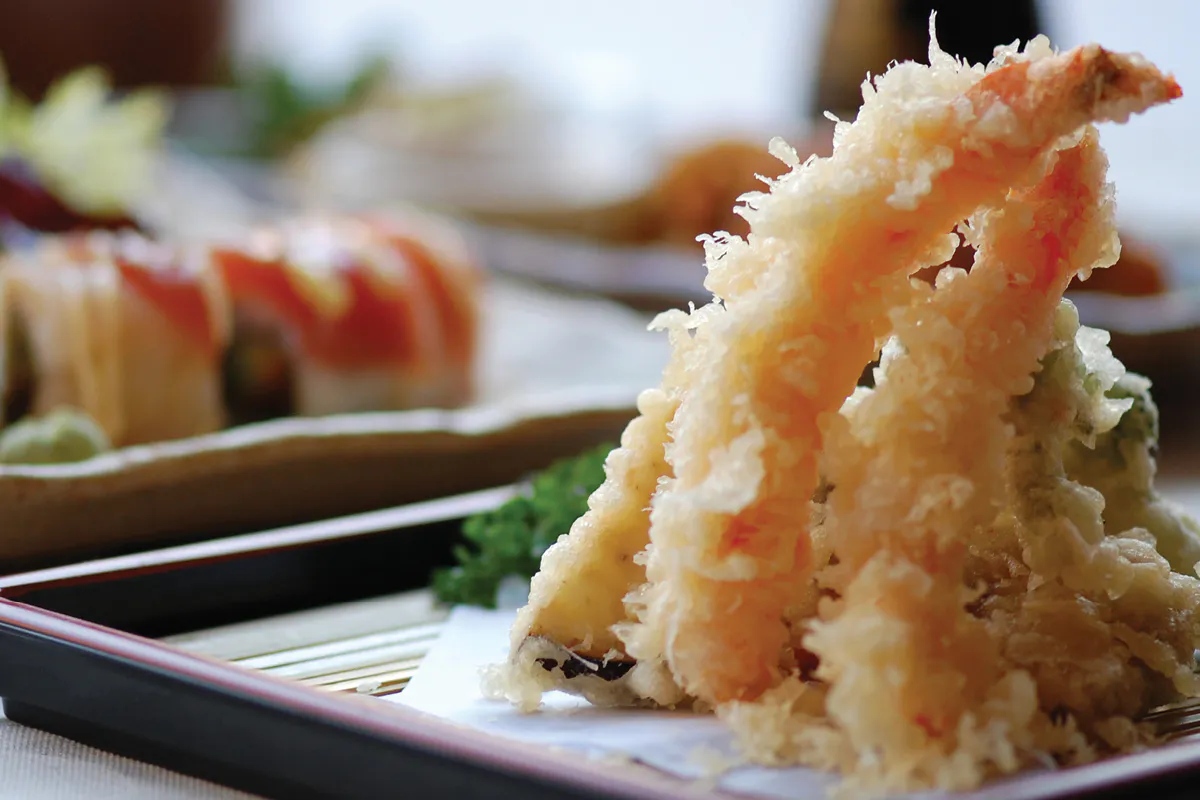 Crispy shrimp tempura with sushi in background at Yahao Asian Cuisine，an Asian Fusion Restaurant in Great Neck