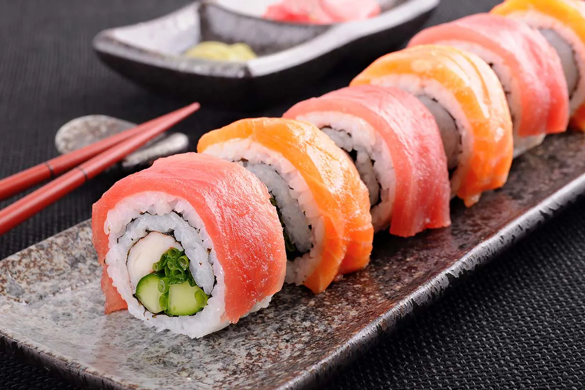 Salmon and tuna sushi roll on ceramic plate at Yahao Asian Cuisine，an Asian Fusion Restaurant in Great Neck